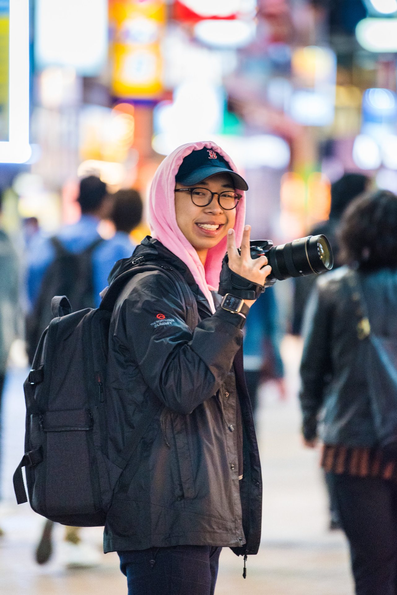 Mico holding a camera on a city street