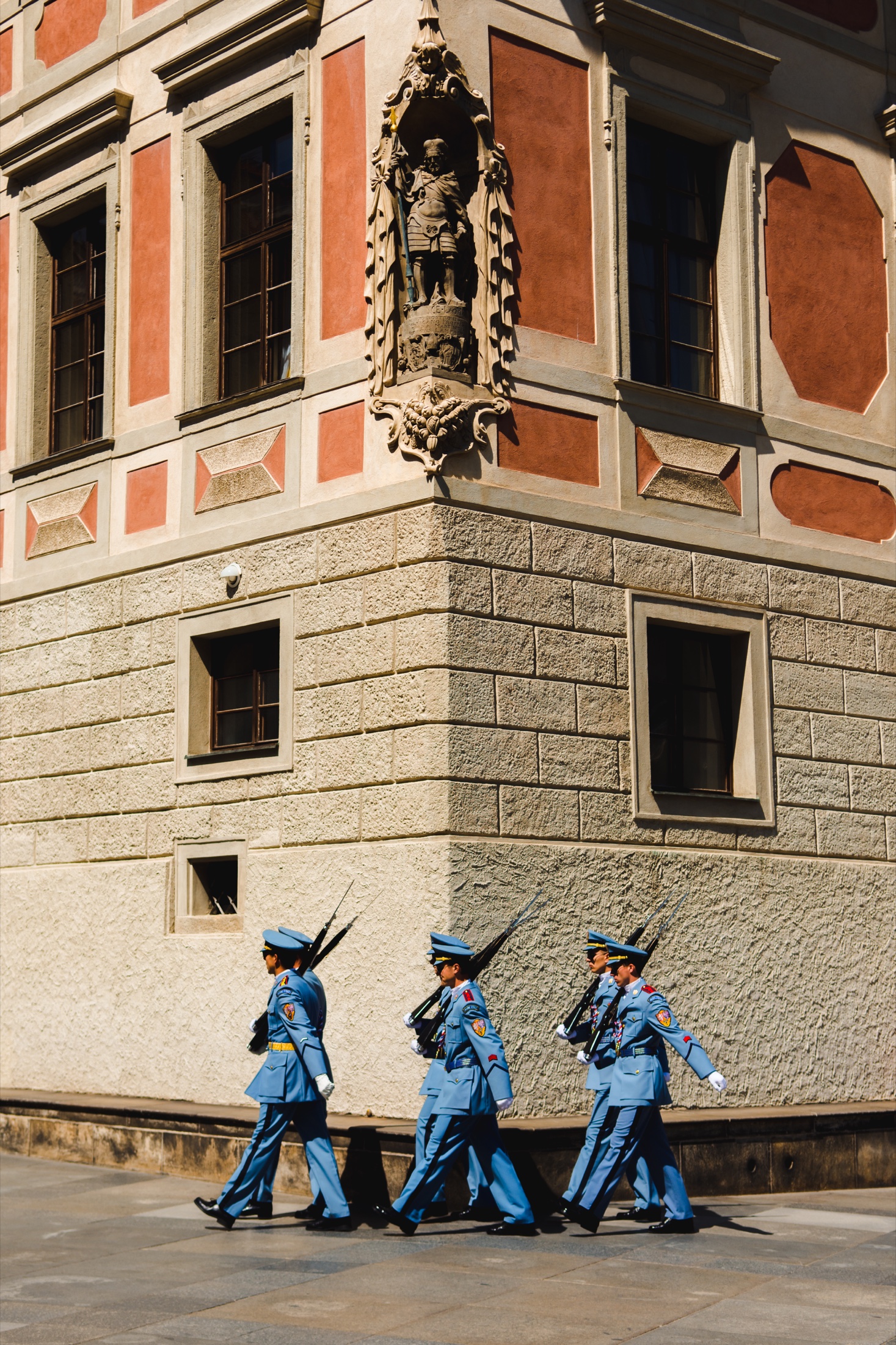 Ceremonial guards marching outside a historic building